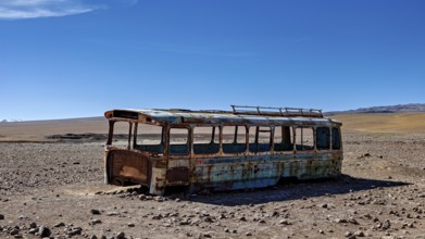A rusty bus stands in a lonely desert landscape under a clear blue sky, An old Bus at the Border
