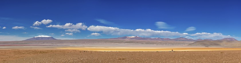 Panorama of a vast desert plain with a majestic mountain panorama under a clear sky, The landscape