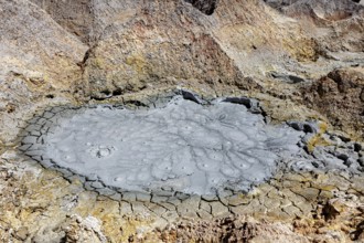 Cracked, brown earth surface with geological structures and craters, The mud volcanoes and