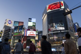 Crowd crossing the zebra crossings of Shibuya Crossing, world-famous intersection in Shibuya