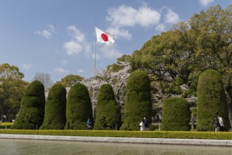 Japanese national flag and artistically trimmed hedges in the Peace Park, sight, UNESCO World
