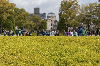 Tourists in the Peace Park with a view of the ruins of the Atomic Bomb Dome, landmark, UNESCO World