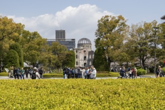 Tourists in the Peace Park with a view of the ruins of the Atomic Bomb Dome, landmark, UNESCO World