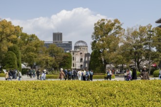 Tourists in the Peace Park with a view of the ruins of the Atomic Bomb Dome, landmark, UNESCO World