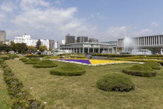 Colourful flower beds and fountains in front of the Hiroshima Peace Museum, tourist attraction,