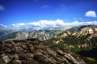 Alpine panorama under a clear sky with rocks and lush landscape. Kleinwalsertal Vorarlberg Austria