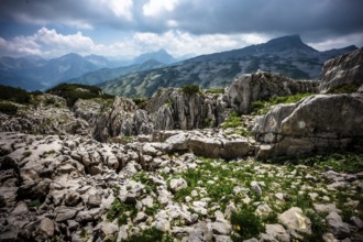 Rocky mountain landscape with cloudy sky and view of distant mountains. Kleinwalsertal Vorarlberg