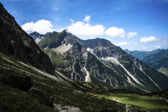 Rocky mountain landscape under a blue sky with clouds on a sunny summer day. Kleinwalsertal