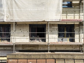 Scaffolding on a building being insulated with thermal insulation panels, Wuppertal, Germany