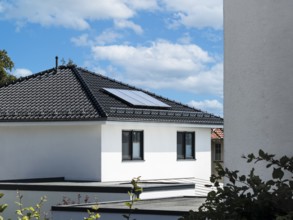 Solar panels on the roof of a new-build detached house in Radevormwald, Germany, digitally reworked