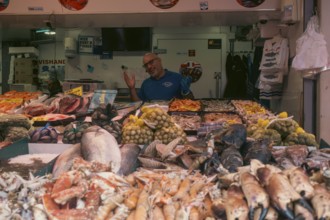 Market vendor with fresh catch at the weekly market market. De Haagse Markt, The Hague, Netherlands