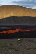 Mountain biking next to flowing lava and an active volcano. Fagradalsfjall, Reykjanes, Iceland