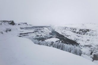 The mighty Gullfoss waterfall in a snowstorm. Golden Cirlce, Haukadalur, Iceland