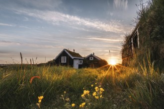 Midnight sun over meadows and peat cottages. Stekkjarkot, Reykjanes, Iceland