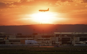Plane on final approach at sunset. Frankfurt am Main Airport, Hesse, Germany