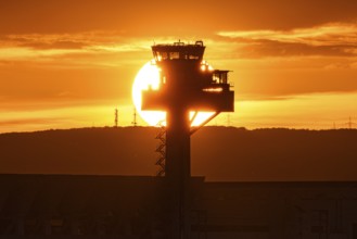 The sun sinks behind the tower. Frankfurt Airport, Hesse, Germany
