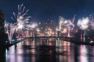 New Year's Eve fireworks illuminate the night skyline on the Main. Frankfurt city centre, Hesse,