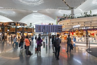 Travellers wait in the bright airport terminal. Istanbul Airport, Arnavutköy, Istanbul, Turkey