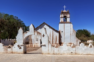 Rustic church with a striking cross under a bright blue sky and clear lines, The church of San