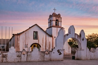 Church at sunset, warm colour palette with illuminated sky and cross tower, The church of San Pedro