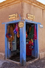 Corner of a souvenir shop with colourful textiles and handicrafts. Rustic style with striking blue