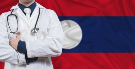 Male doctor with stethoscope on Laotian flag. Doctor holding stethoscope on Laos flag