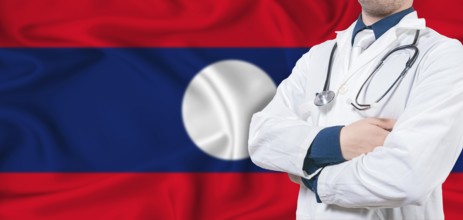 Laos healthcare concept. Male doctor on Laos flag. Doctor with crossed arms on Laos flag