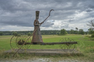 Sculpture Charon ferryman into the underworld, dyke near Mödlich, Brandenburg, Germany