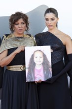 Venice, Italy - 3 September 2025: Kaouther Ben Hania, Saja Kilani with a portrait of the