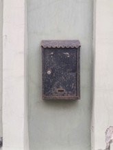 Old metal mailbox hanging on the wall of the house, copy space