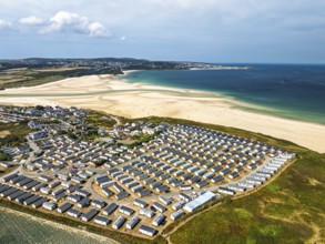 Holiday homes over Hayle Beach and Hayle Estuary from drone, St Ives Bay, Cornwall, England, United