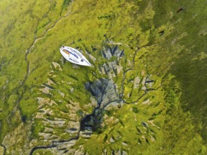Top Down over boat and mud from drone, Paulsgrove Lake, Portchester Castle, Portchester, Fareham,