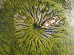 Top Down over boat and mud from drone, Paulsgrove Lake, Portchester Castle, Portchester, Fareham,
