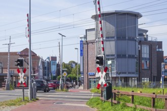 Gated railway crossing with houses, Leer, East Frisia, Lower Saxony, Germany