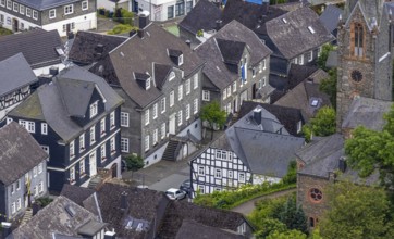 Aerial view, Protestant town church and green trees on Schlossstraße, residential area with