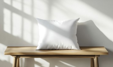 A white pillow sits on a wooden bench in front of a white wall. The pillow is empty and the bench