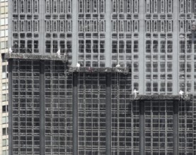 Detail shot of some facade workers on a skyscraper facade in New York (USA)