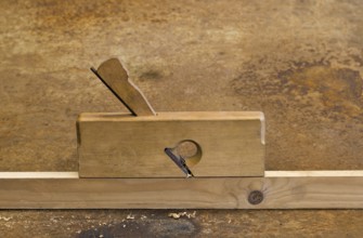 Old planer on wooden plank