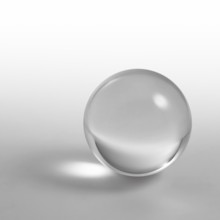 A clear crystal ball and light reflections in grey gradient back