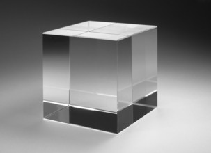 Studio photography of a solid glass cube in gradient back