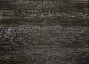 A full frame dark burnt wood grain surface