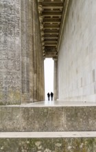 Colonnade and two human silhouettes at the Walhalla memorial near Regensburg in Bavaria, Gerrmany