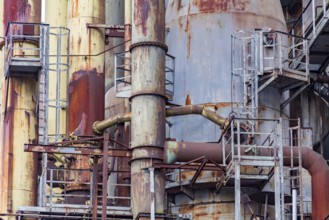 Weathered rusty industrial scenery with old corroded steel girders and metal tubes