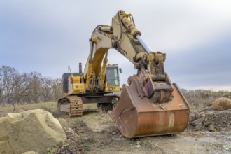 A yellow Excavator in stony ambiance