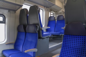 Scenery inside a railway car with blue seats
