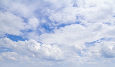 Full frame sky scenery with some sunny illuminated clouds