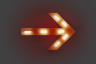 Red illuminated arrow on a wall in grey ambiance