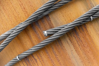 Closeup shot of wire ropes on rusty ground