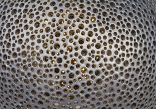 Full frame bent metallic perforated background