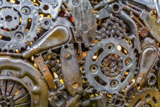 Full frame warm illuminated metallic mechanical background with gear wheels and other material